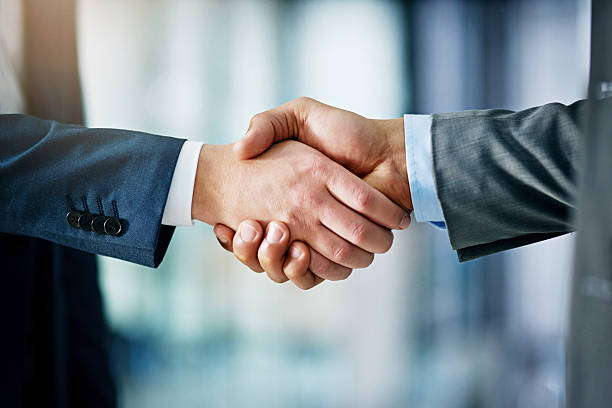 Business partnership handshake